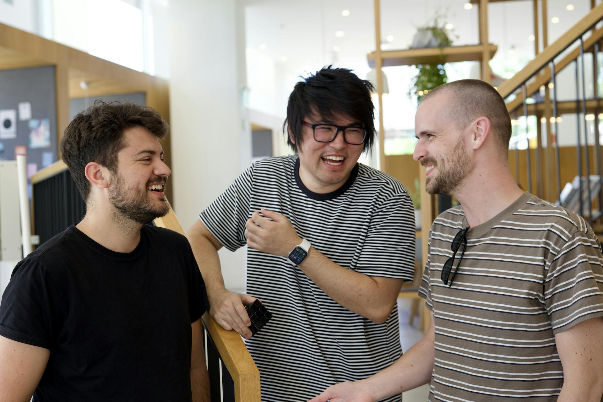 A picture of the Resend founding team, 3 people smiling in a coworking space 