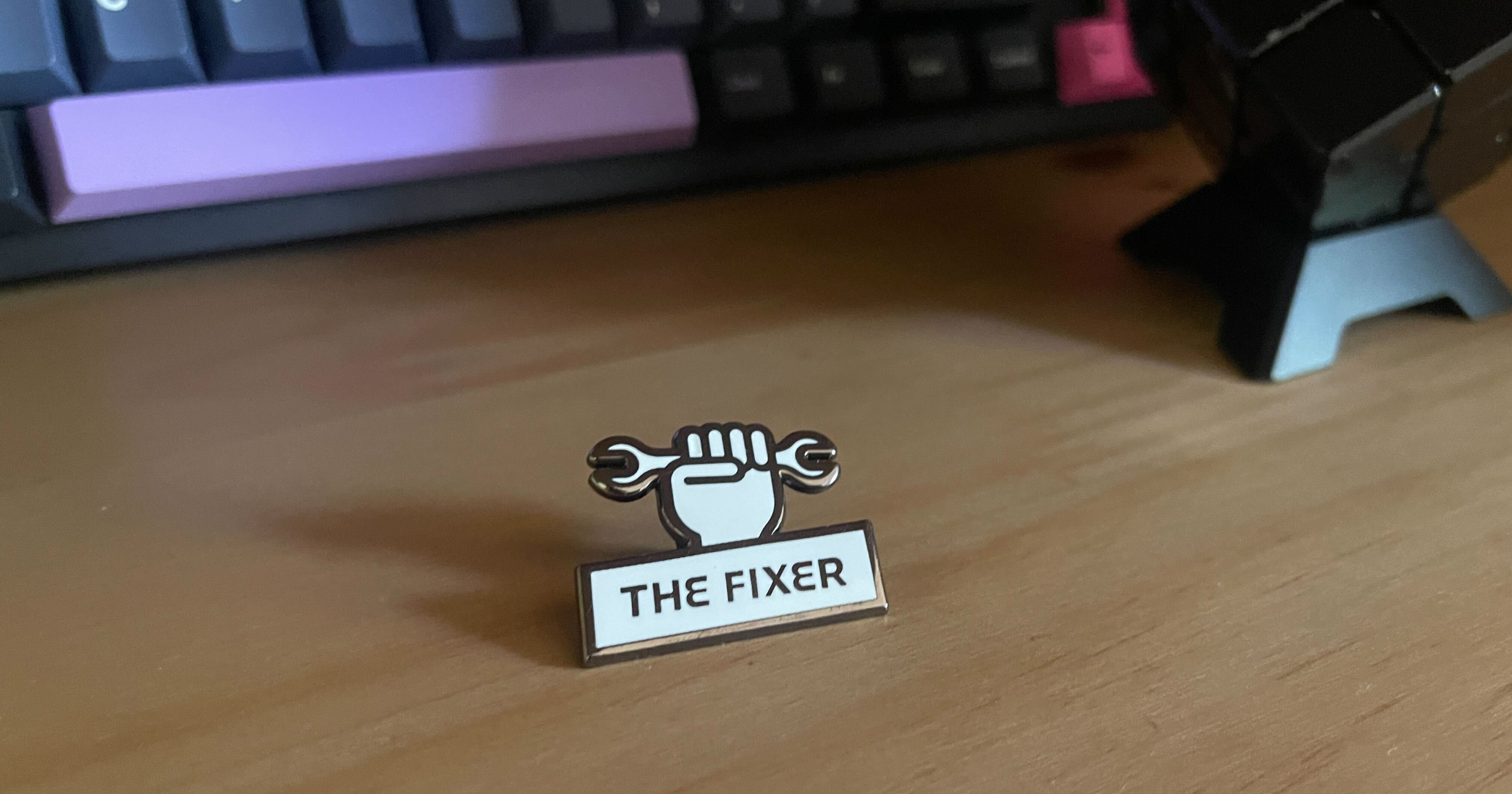 The Fixer role enamel pin